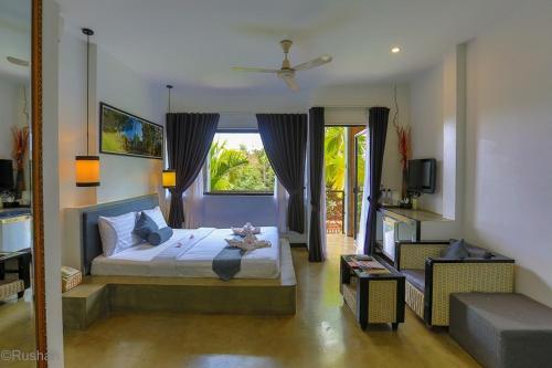 a bedroom with a bed and a large window at Apsara Greenland Boutique Villa & Resort in Siem Reap