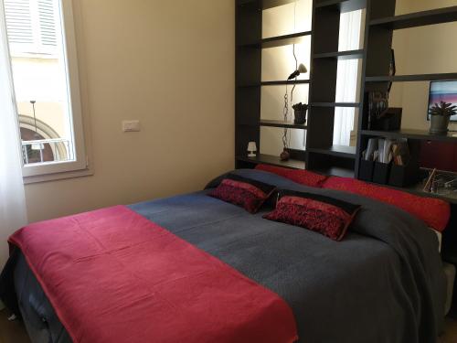 a bedroom with two beds with red and blue sheets at Saint George and the Dragon Suite in Bologna
