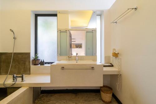 a bathroom with a sink and a mirror at Apsara Greenland Boutique Villa & Resort in Siem Reap