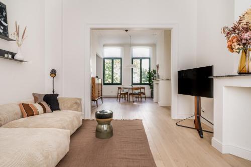 a living room with a couch and a fireplace at Quartier Le Sud in Antwerp