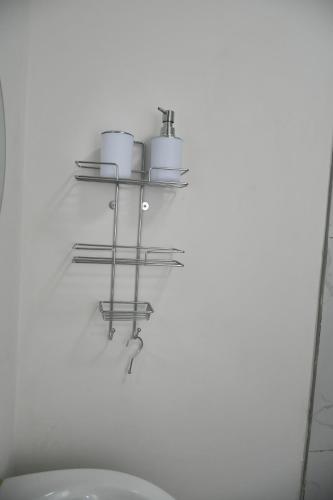 a bathroom with a shelf with pots and pans on the wall at Ndlovu Palace in Ragbubee