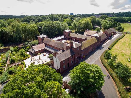 an aerial view of an old building with trees at Lovely 2 Bedroom Serviced Apartment with Parking in West Bromwich