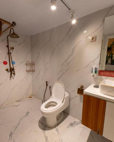 a bathroom with a toilet and a sink at White Swan Private VIlla in Tlekung