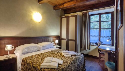 um quarto com uma cama, um lavatório e uma janela em Fermata Alpi Graie 