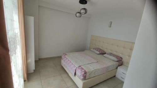 a bedroom with a bed in a white room at gazlıgöl elit termal otel in Gazligol