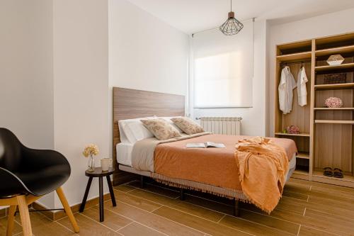 um quarto com uma cama e uma cadeira em Estilo japandi Sardinero em Santander