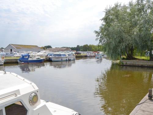 a group of boats are docked in a river at Maud - Uk12693 in Stalham