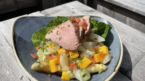 a plate of food with meat and vegetables on a table at Holiday Inn Düsseldorf-Neuss by IHG in Neuss