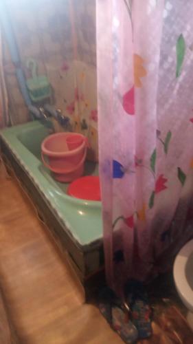 a toy kitchen with dishes and a shower curtain at New Dunhill Houseboat in Srinagar