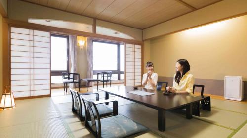 two women sitting at a table in a room at Hotel Morinokaze Oshuku in Shizukuishi