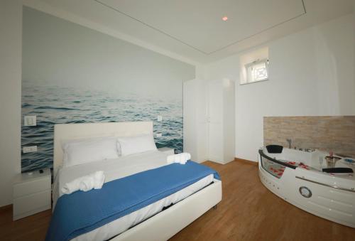 a bedroom with a bed and a boat in it at Vient' e mar suite in Castellammare di Stabia