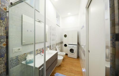 a bathroom with a sink and a washing machine at Vient' e mar suite in Castellammare di Stabia