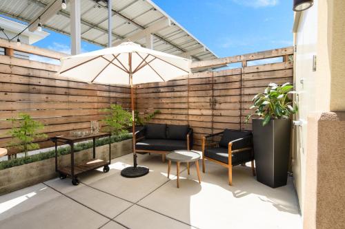 a patio with a table and an umbrella and chairs at Holiday Inn Express Hotel & Suites Atascadero by IHG in Atascadero