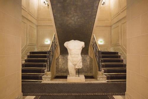 
a large room with a stairway leading up to it at Hôtel Napoleon Paris in Paris
