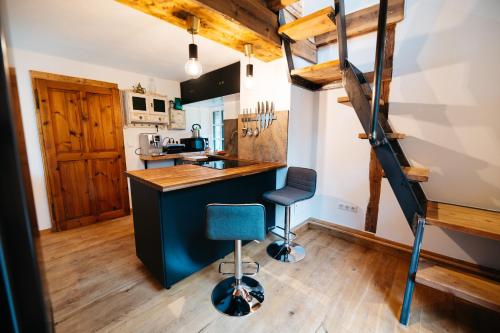 a kitchen with a counter and a blue chair at Chalet am Sonnenhang in Obertraun