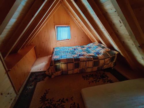 a small attic room with a bed in a attic at Prokosko Resort in Fojnica