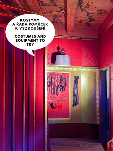 a room with colorful curtains and a poster on the wall at OROOM St Petersburg - Role Play For Couples in BRNO in Brno