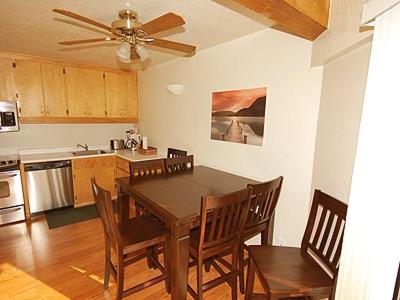 a kitchen with a table and chairs and a ceiling fan at Ala WaiApartment in South Lake Tahoe