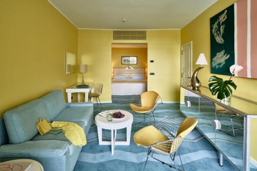 a living room with a couch and chairs and a bed at Seaside Palm Beach in Maspalomas