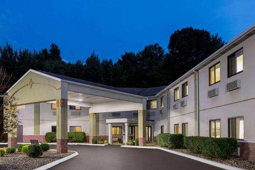 a large white building with a parking lot at Super 8 by Wyndham Grove City in Grove City