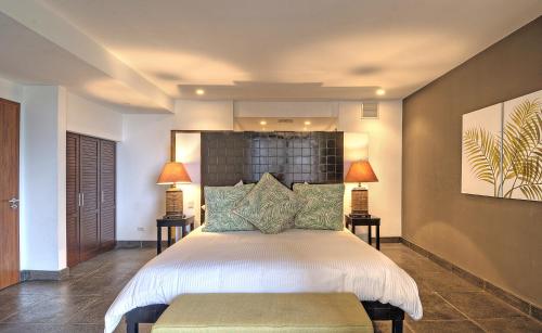 a bedroom with a large bed and a large window at Los Altos Resort in Manuel Antonio