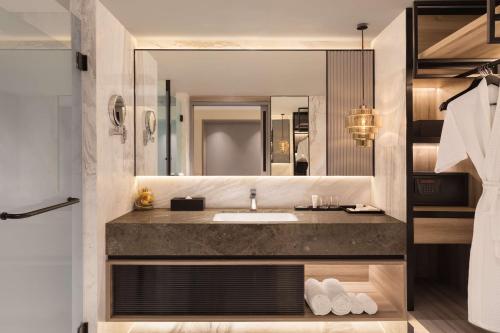 a bathroom with a sink and a mirror at Radisson Mumbai Goregaon in Mumbai