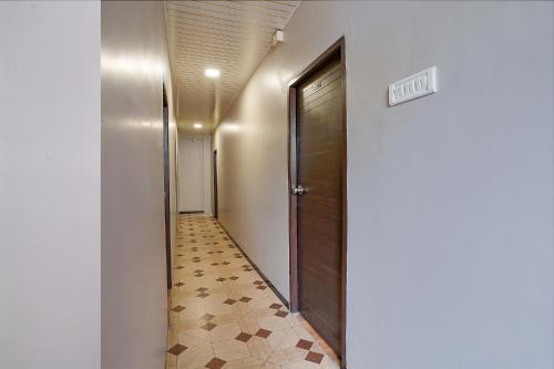 a hallway with a door and a tile floor at FabExpress Comfort Stay in Mumbai