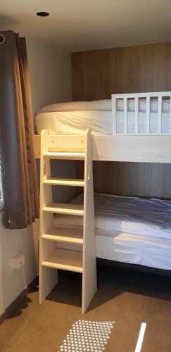 a bunk bed with two bunk beds next to each other at Bungalows Portuondo parking gratuito in Mundaka