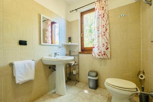 a bathroom with a toilet and a sink at Agriturismo Il Paradiso in Iglesias