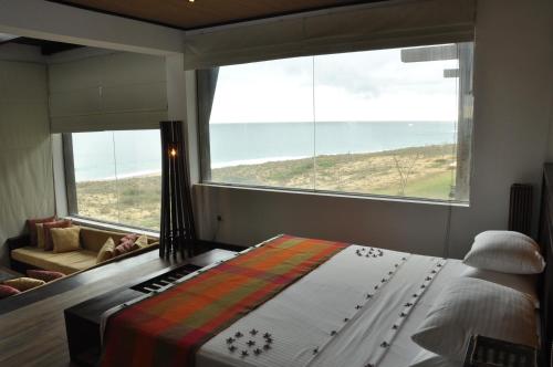 a bedroom with a bed and a large window at Laya Safari Resorts & Spa in Yala
