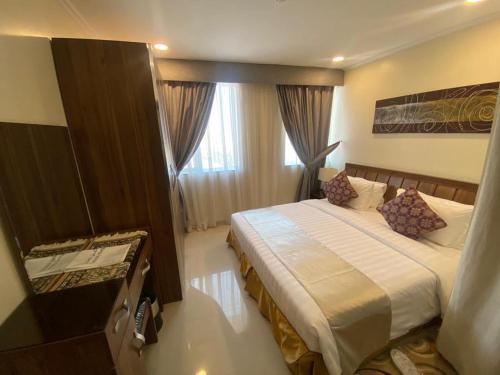 a hotel room with a bed and a window at Burj Alawal in Al Jubail