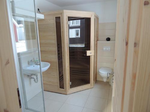 a bathroom with a shower and a toilet and a sink at Haus Annette in Glowe