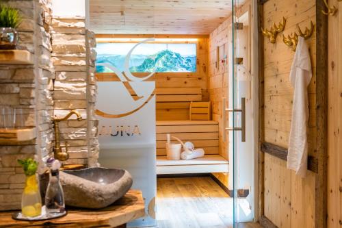 a sauna with a tub and a window at Hotel-Restaurant Burgblick in Dorfgastein