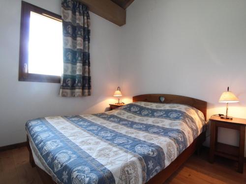 a bedroom with a bed and a window and two lamps at Appartement Aussois, 3 pièces, 6 personnes - FR-1-508-36 in Aussois