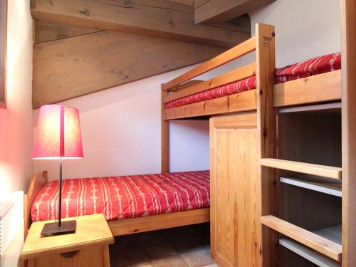 une chambre avec deux lits superposés et une lampe dans l'établissement Appartement pour 6 au pied des pistes avec parking, balcon et WIFI – Val Cenis - FR-1-508-129, à Lanslevillard