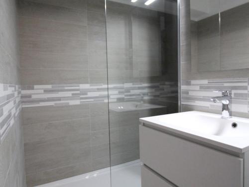 a bathroom with a shower and a sink and a tub at Appartement Lanslevillard, 1 pièce, 5 personnes - FR-1-508-82 in Lanslevillard