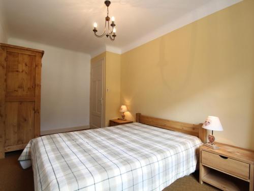 a bedroom with a bed and a chandelier at Spacieux appartement 5 pers, balcon, WiFi - Lanslebourg - FR-1-508-154 in Lanslebourg-Mont-Cenis