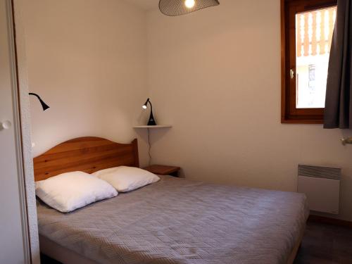 a bedroom with a bed with two white pillows at Appartement Aussois, 3 pièces, 6 personnes - FR-1-508-115 in Aussois