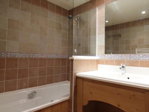 une salle de bain avec un lavabo, une baignoire et un miroir dans l'établissement Appartement à Val-Cenis - 4 pers, pied des pistes, piscine, balcon, parking, WiFi gratuit - FR-1-508-149, à Lanslebourg-Mont-Cenis