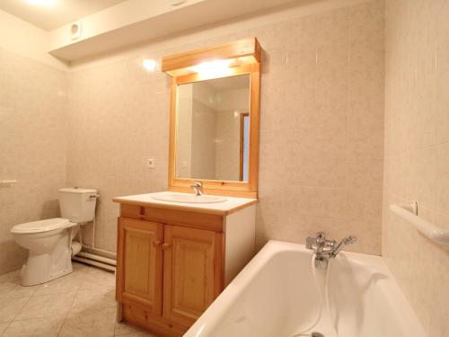 a bathroom with a tub and a sink and a toilet at Appartement Aussois, 2 pièces, 4 personnes - FR-1-508-175 in Aussois