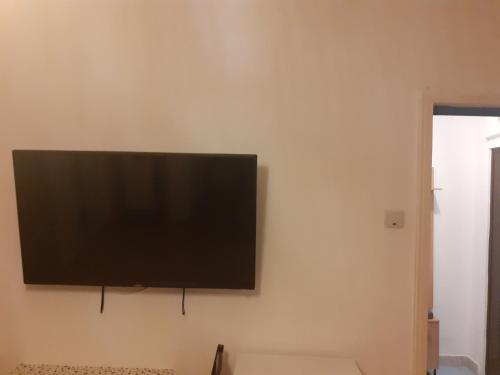 a flat screen tv hanging on a wall at Happy central Bucharest acomodation in Bucharest