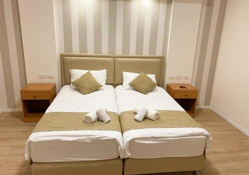 a bedroom with a bed with two pillows on it at Grand Hotel Bethlehem in Bethlehem