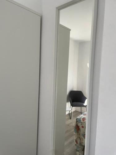 a mirror in a room with a black chair at Eras Views in Las Eras
