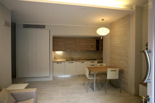 a kitchen with a table and a dining room at Nina Casa Vacanze in Finale Ligure