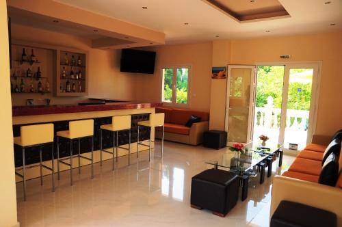 a living room with a bar and a couch at Hotel Penelope in Boukari