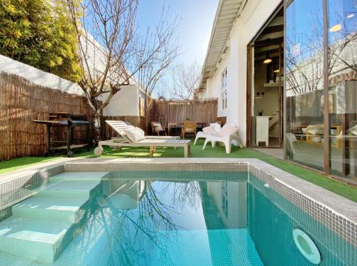 a swimming pool in the backyard of a house at Casa Lavander in Barcelona