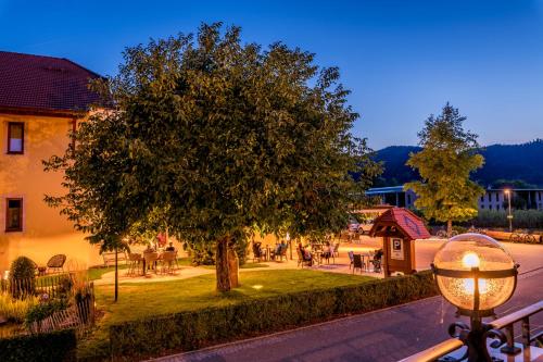 a tree on the side of a street with a park at Mosers Blume Relax & Genuss Hotel in Haslach im Kinzigtal
