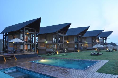 a large building with a swimming pool in front of it at Laya Safari Resorts & Spa in Yala
