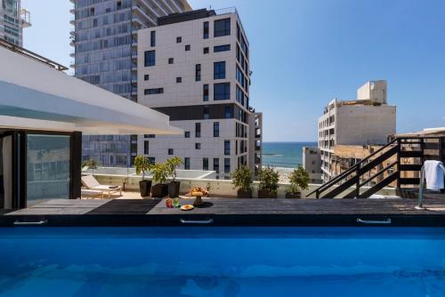 a swimming pool with a view of the city at Brown Beach House Tel-Aviv, a member of Brown Hotels in Tel Aviv