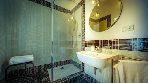 a bathroom with a shower and a sink and a mirror at La Terrazza in Arezzo